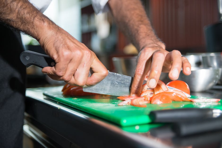 Professional custom kitchen knives by Zira Cutlery displayed on cutting board in modern kitchen setting